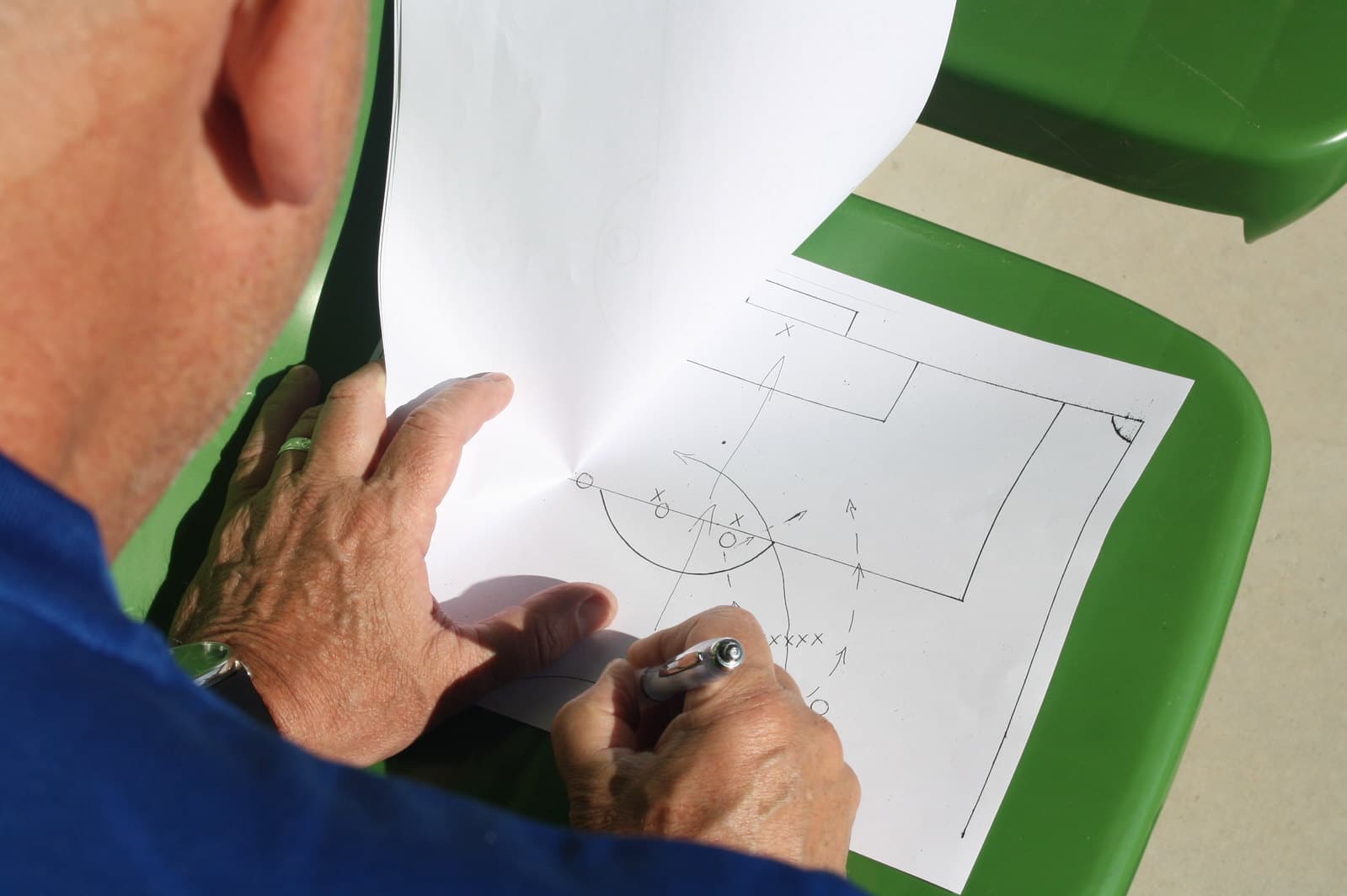 Youth soccer coach drawing tactical formations for player development